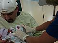 Jason holding Harrison for the first time
